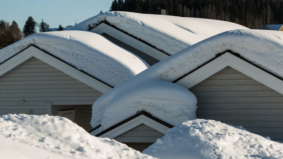 Snow piled up on roofs of homes in michigan